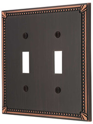 Imperial Bead Double Toggle Switch Plate in Aged Bronze.